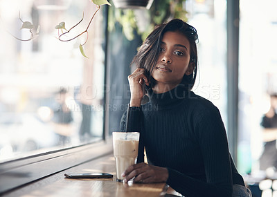 Buy stock photo Shot of a beautiful young woman drinking a iced coffee in a cafe