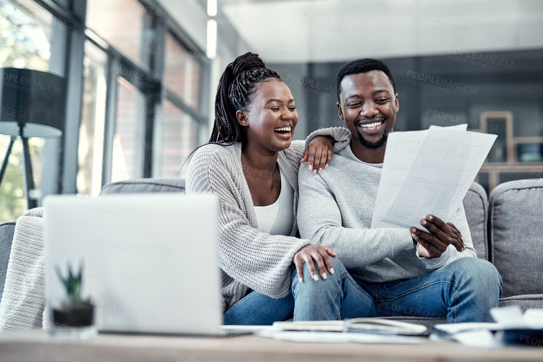 Buy stock photo Happy, smiling and carefree black couple checking their finances on a laptop at home. Cheerful husband and wife excited about their financial freedom, savings, investment and future planning
