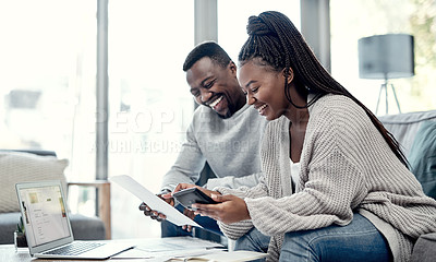 Buy stock photo Shot of a young couple going through paperwork at home