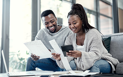 Buy stock photo Shot of a young couple going through paperwork at home