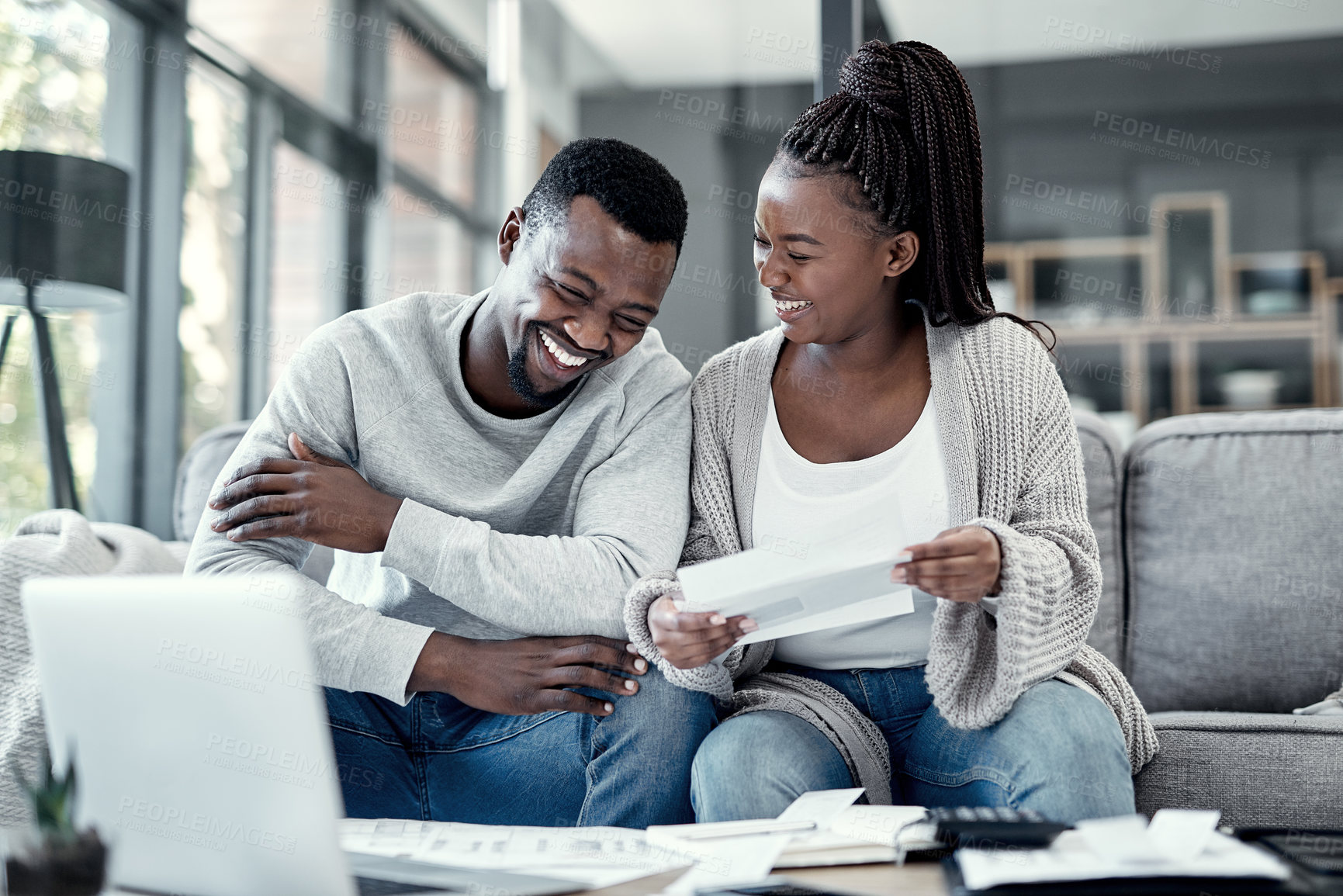 Buy stock photo Happy black couple paying bills on a laptop at home, checking their budget and savings. Smiling African american husband and wife enjoying future planning, excited about an investment and good credit