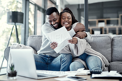 Buy stock photo Smiling, happy and hugging couple enjoying, embracing and loving remote work together at home. Young romantic partners working online and celebrating successful news or job success letter on a sofa