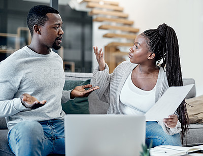 Buy stock photo Shot of a young couple having an argument while working on their finances at home
