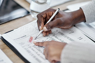 Buy stock photo Shot of an unrecognisable couple going through paperwork at home