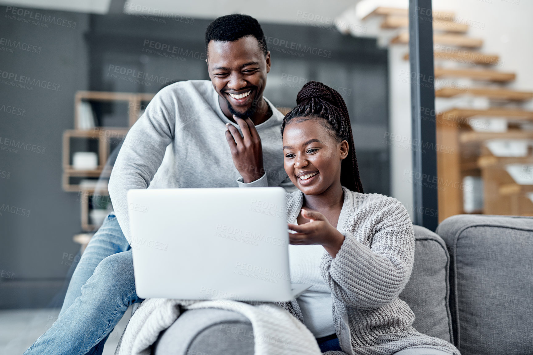 Buy stock photo Shot of a young couple using a laptop together on the sofa at home