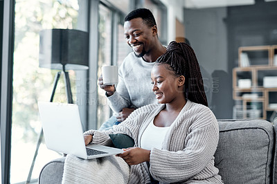 Buy stock photo Shot of a young couple using a laptop together on the sofa at home