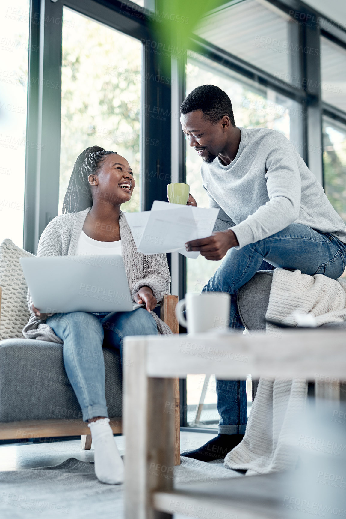 Buy stock photo Shot of a young couple going through paperwork at home