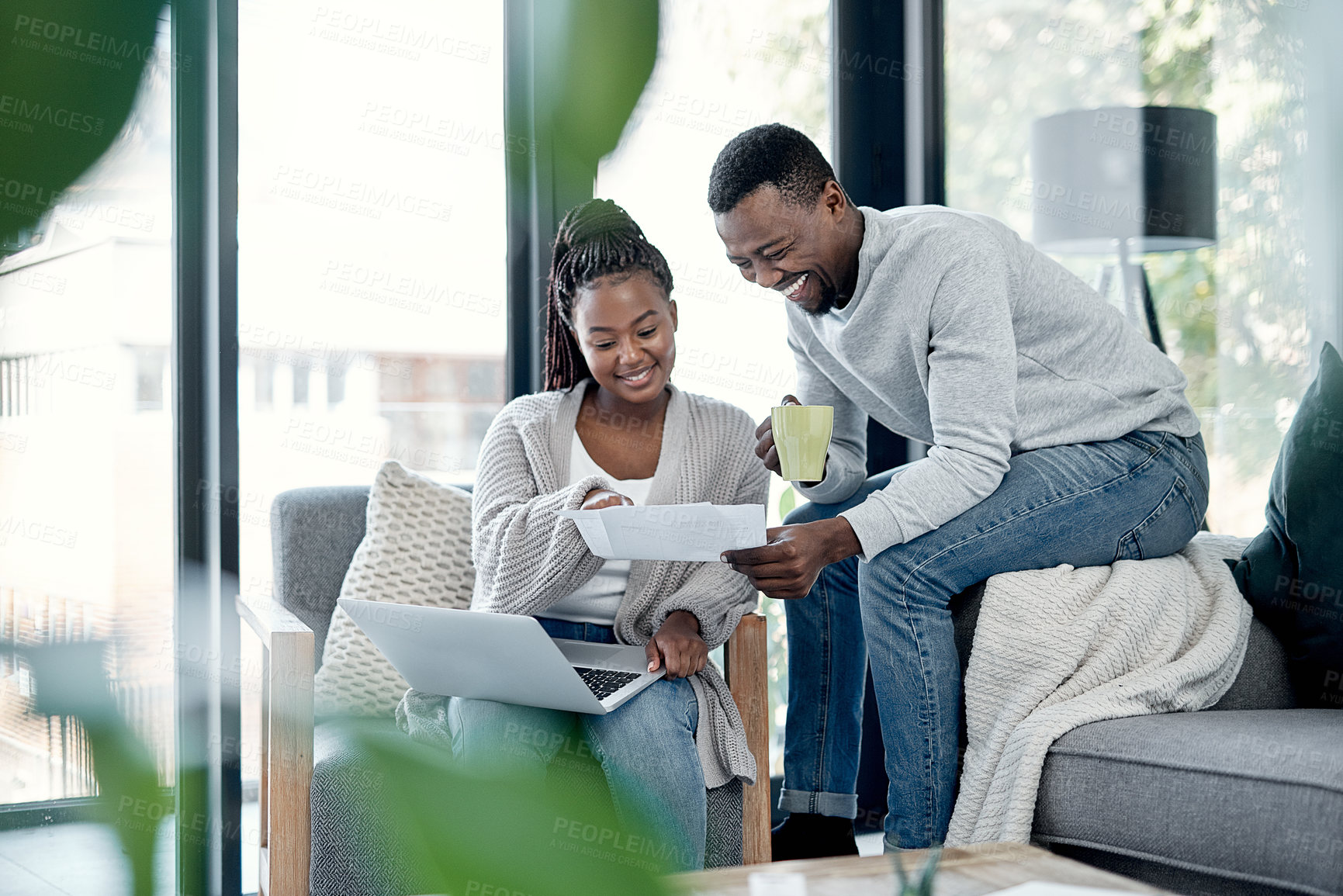 Buy stock photo Shot of a young couple going through paperwork at home