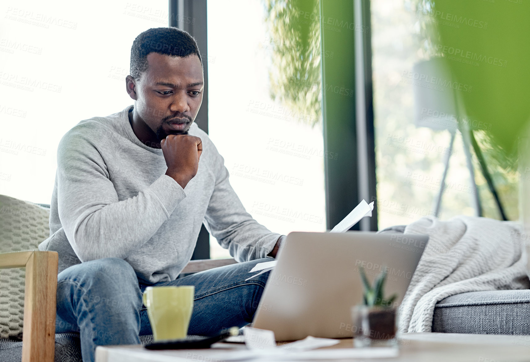 Buy stock photo Finance, stress and worried black man paying bills on a laptop while doing paperwork at home. Concerned, anxious male checking budget, getting bad news or negative feedback of a rejected loan or debt