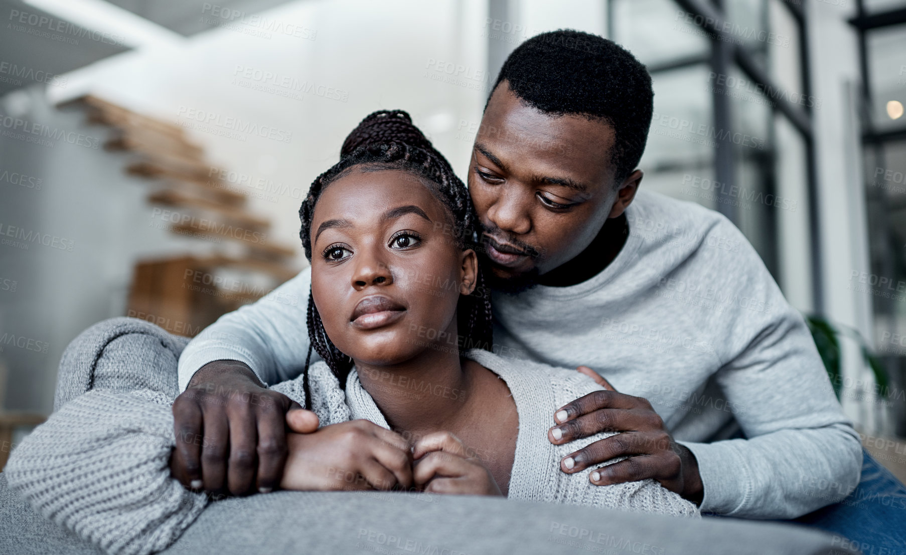 Buy stock photo Unhappy, sad and depressed couple while boyfriend comfort, support and hug partner while struggling, mourning loss or depression problem at home. Asking forgiveness after argument about cheating