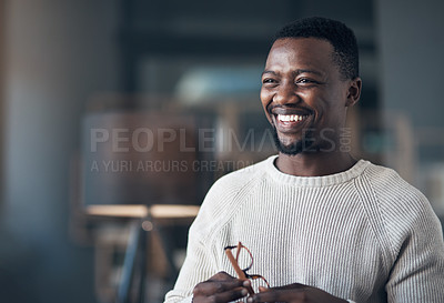 Buy stock photo Cropped shot of a handsome young man standing alone in his living room during the day