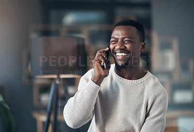 Buy stock photo Cropped shot of a handsome young man sitting alone in his living room and using his cellphone