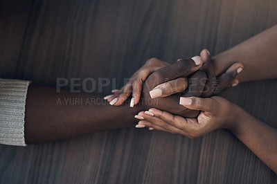 Buy stock photo Cropped shot of an unrecognizable couple holding hands while at home during the day