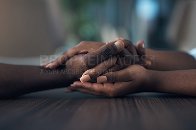 Buy stock photo Cropped shot of an unrecognizable couple holding hands while at home during the day