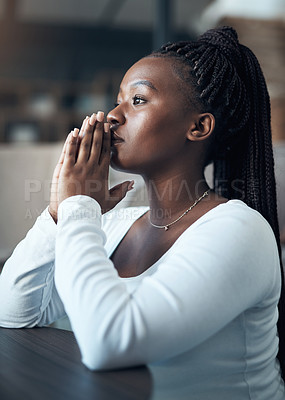 Buy stock photo Cropped shot of an attractive young woman kneeling alone and praying in her home