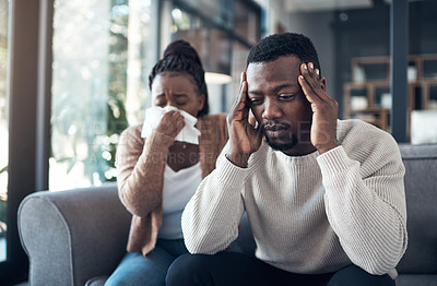 Buy stock photo Cropped shot of a young couple sitting in their living room and feeling sick