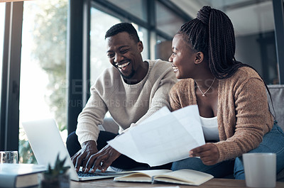 Buy stock photo Cropped shot of a young couple sitting on the sofa together and using a laptop while going through their finances