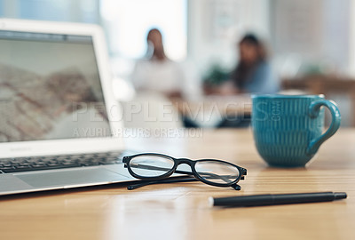 Buy stock photo Closeup shot of spectacles and a laptop on a table in an office