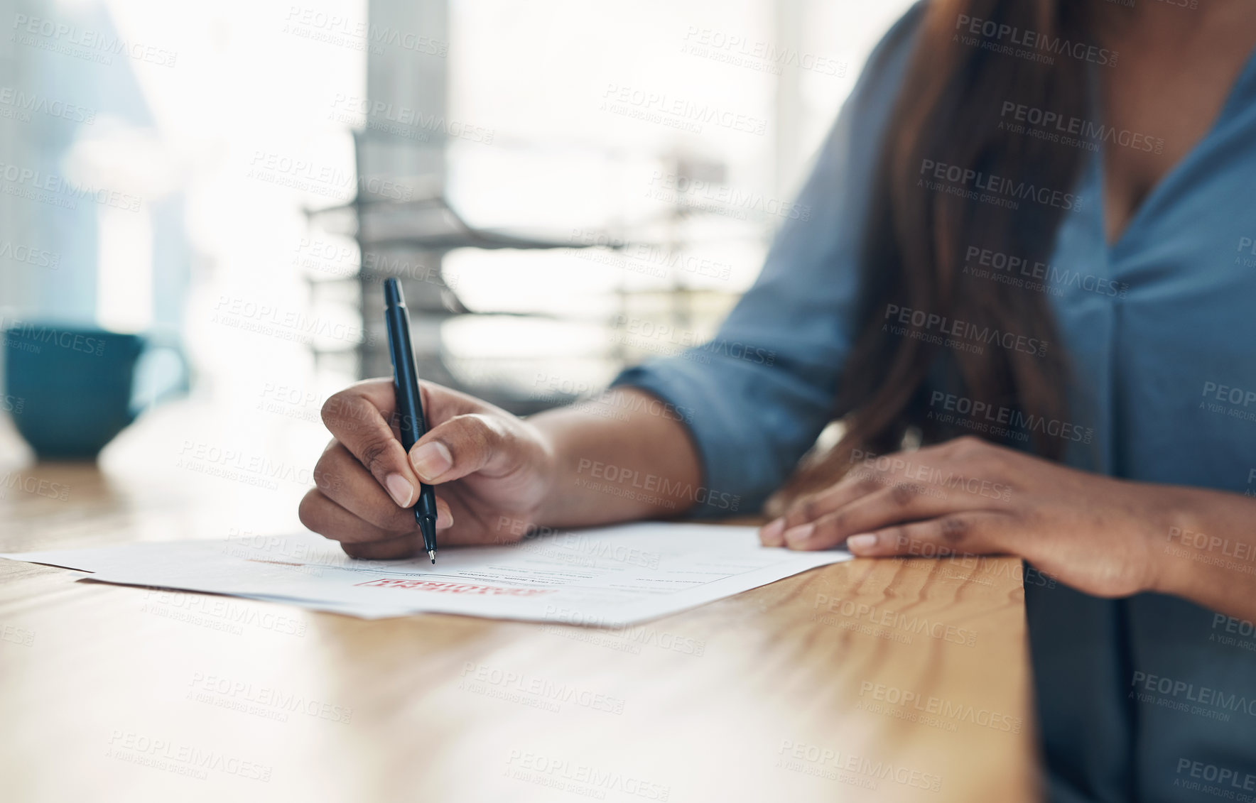 Buy stock photo Closeup shot of an unrecognisable businesswoman filling in paperwork in an office