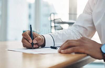 Buy stock photo Closeup shot of an unrecognisable businessman filling in paperwork in an office