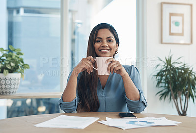 Buy stock photo Portrait of a young businesswoman drinking coffee while working in an office