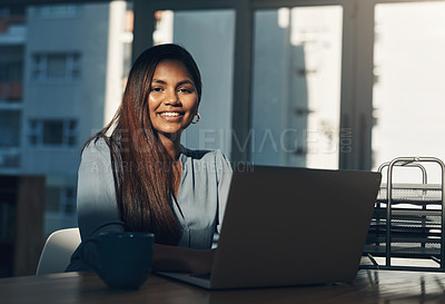 Buy stock photo Portrait of a young businesswoman using a laptop in an office