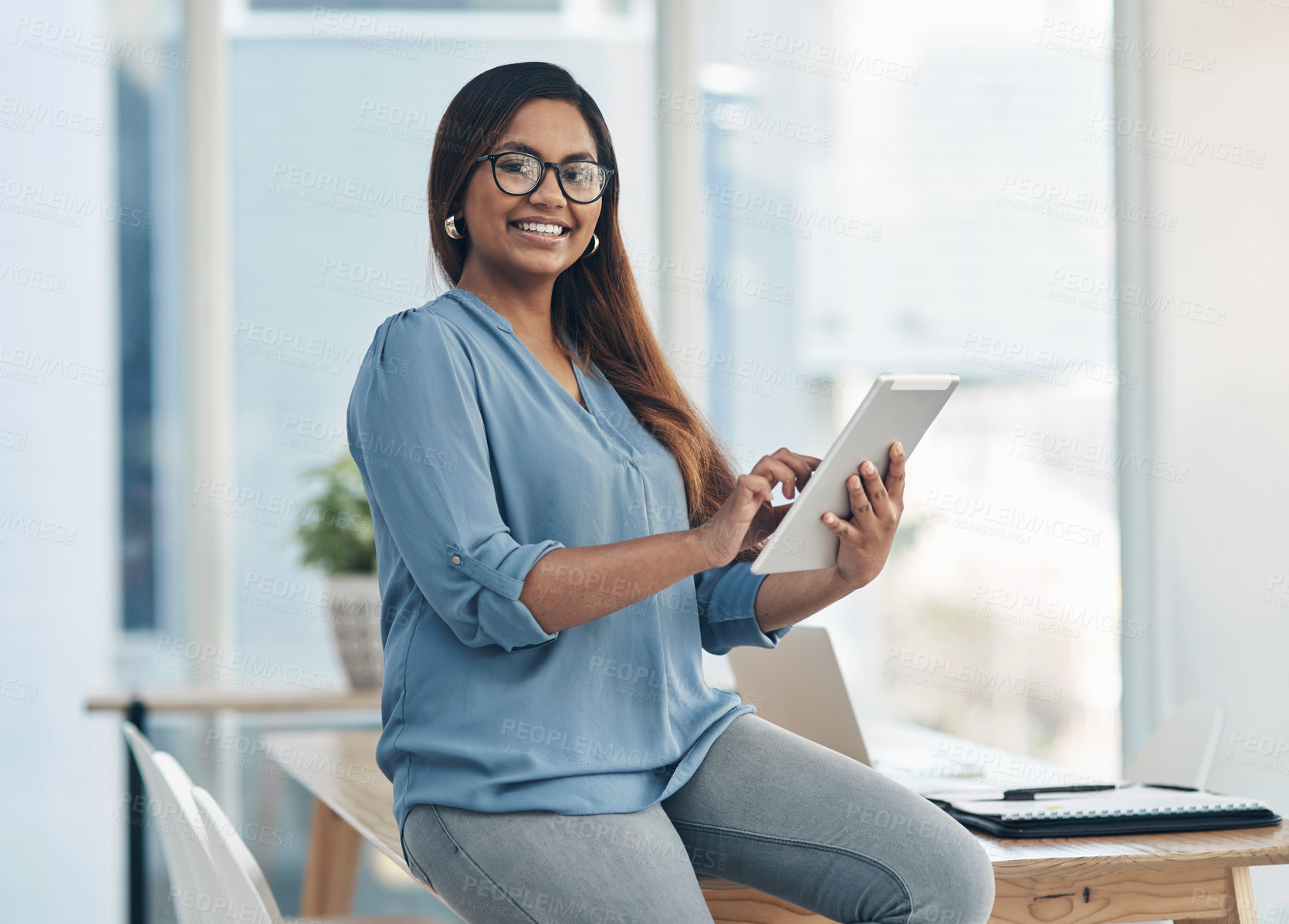 Buy stock photo Portrait of a young businesswoman using a digital tablet in an office