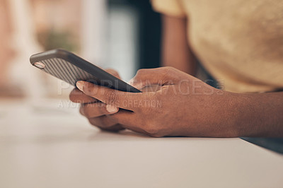 Buy stock photo Shot of a woman using a smartphone while working from home