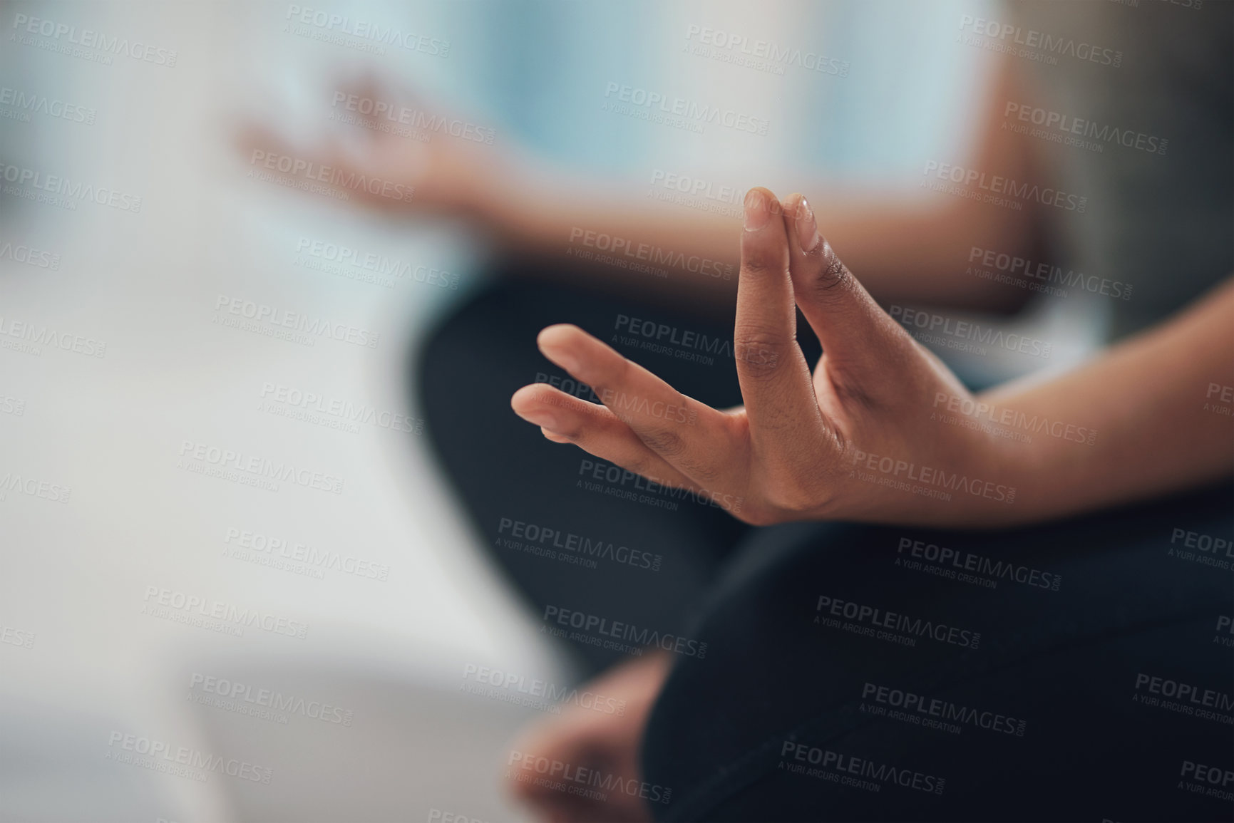 Buy stock photo Cropped shot of an unrecognisable woman meditating in the lotus position