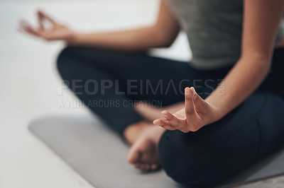 Buy stock photo Cropped shot of an unrecognisable woman meditating in the lotus position