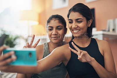 Buy stock photo Peace sign, exercise selfie and women together at home for social media memory, emoji or post. Indian sisters or female friends taking photo for influencer update, fitness motivation or happy results