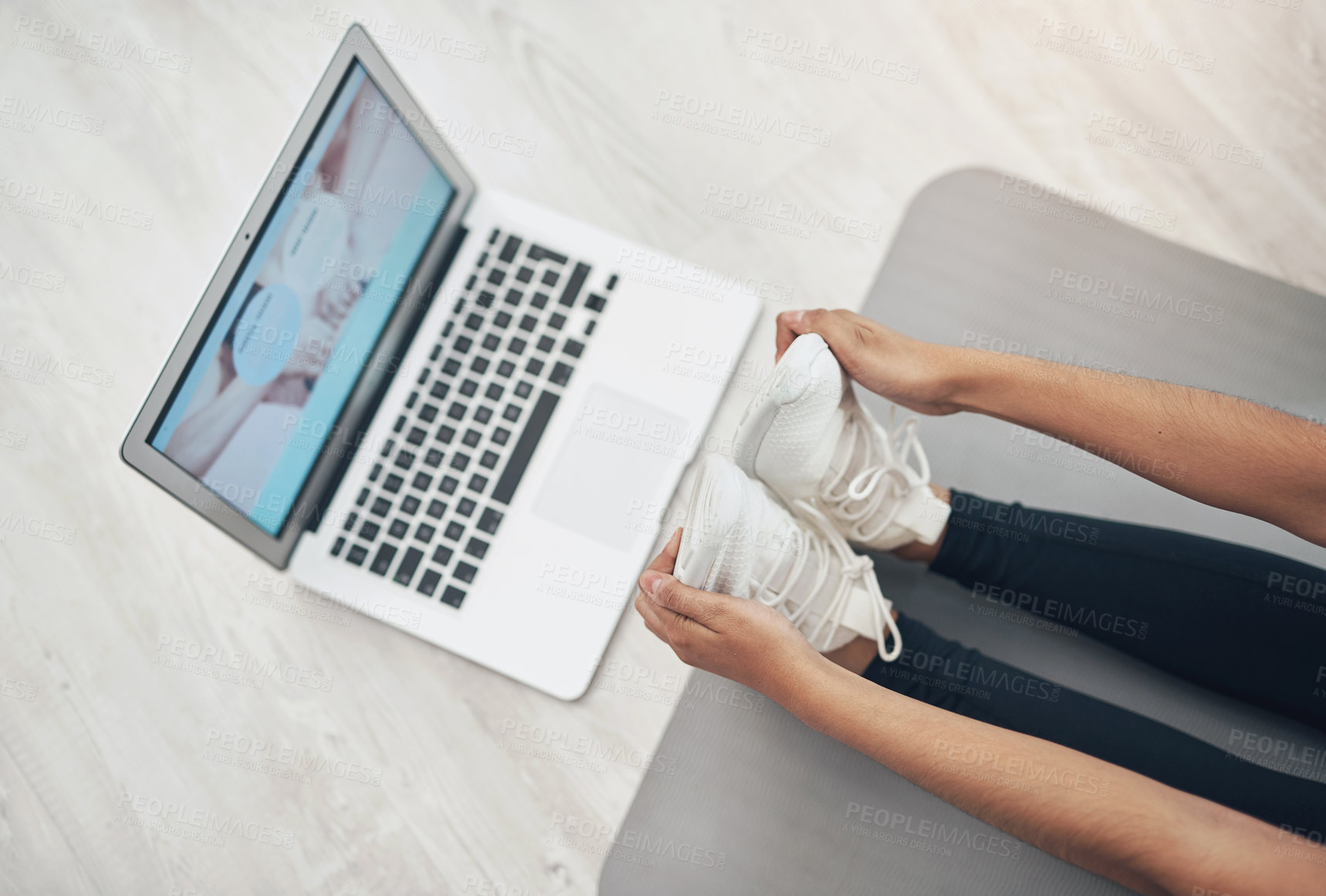 Buy stock photo Shot of a woman using her laptop while exercising at home