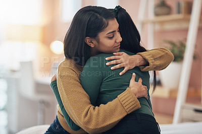 Buy stock photo Cropped shot of two young women embracing each other at home