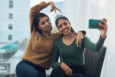 Buy stock photo Peace sign, selfie and smile with sisters in living room of home together for bonding, love or memories. App, hand gesture or profile picture with girl siblings in city apartment for photograph