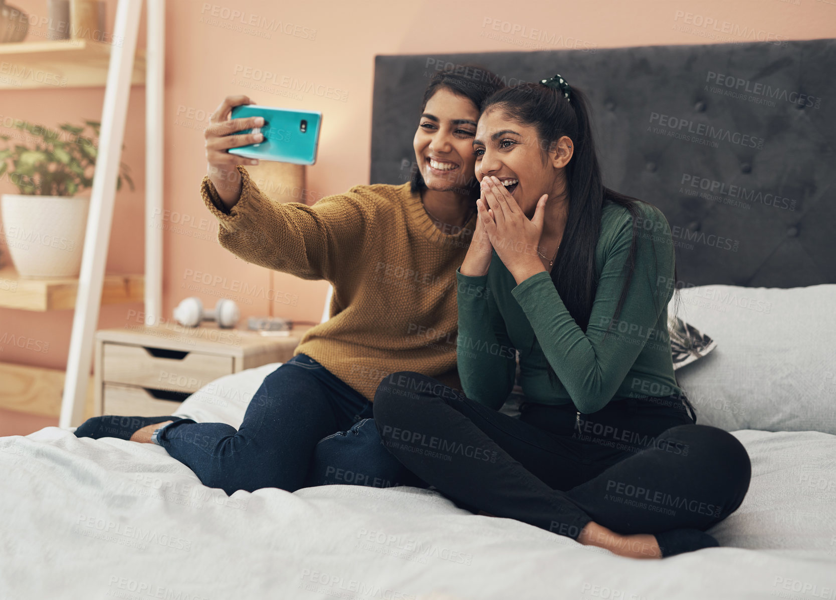 Buy stock photo Selfie, social media and wow with sisters on bed in home together for bonding, love or memories. App, profile picture and surprise with girl siblings in apartment for weekend photograph as family