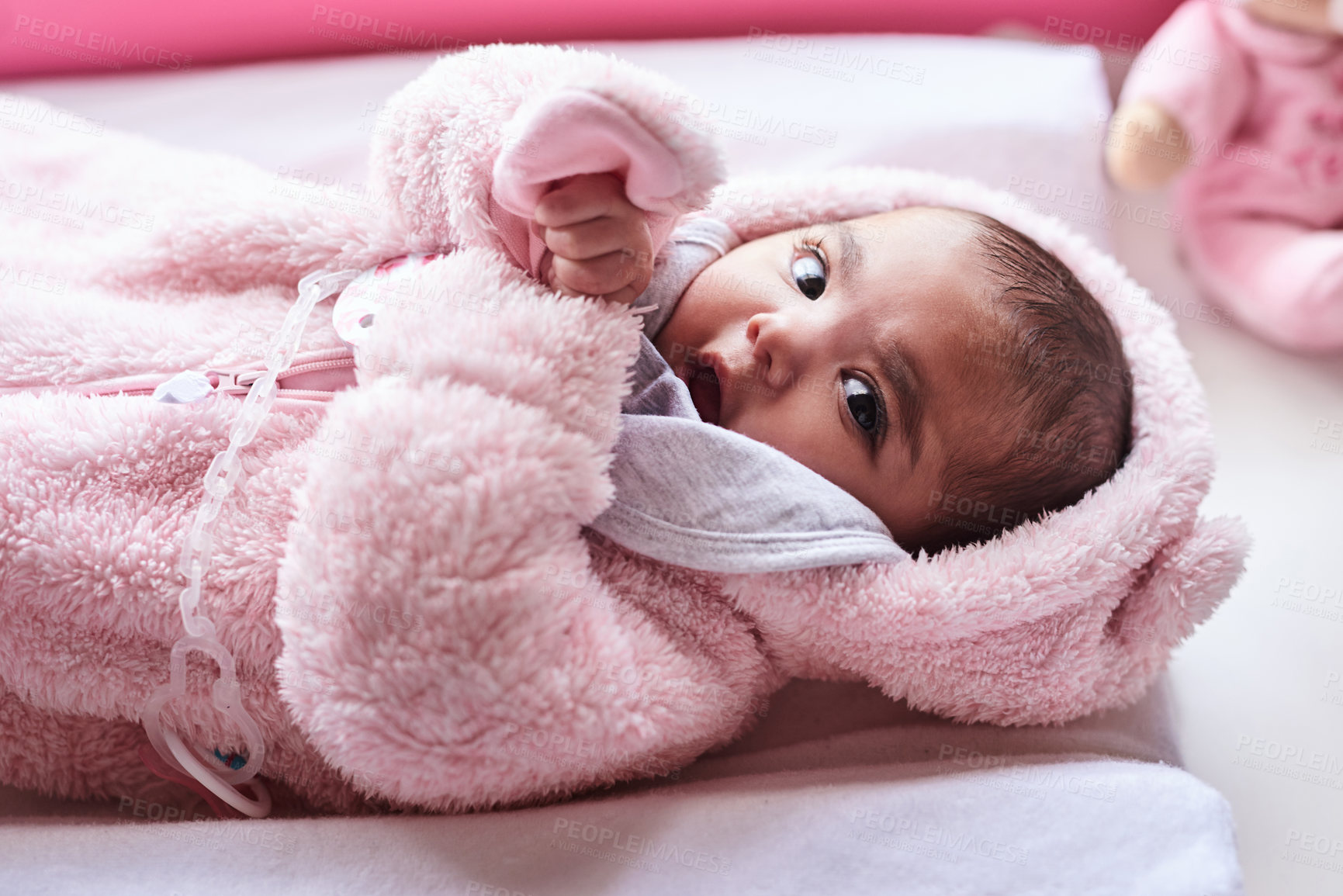 Buy stock photo Shot of an adorable baby girl on a diaper changing station at home