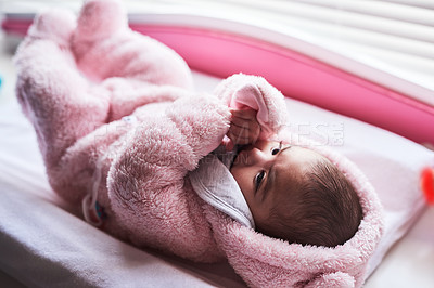 Buy stock photo Shot of an adorable baby girl on a diaper changing station at home