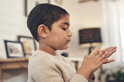 Buy stock photo Shot of an adorable little boy disinfecting his hands at home