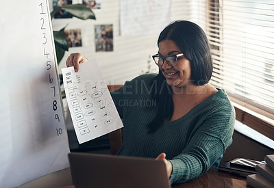 Buy stock photo Shot of a young woman using a laptop to teach a lesson from home