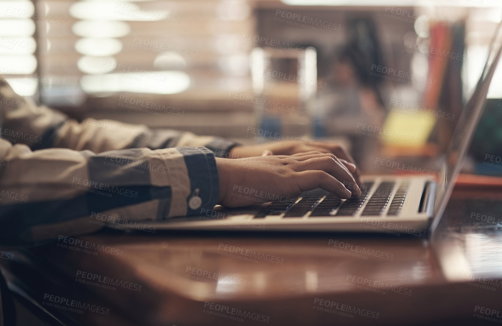 Buy stock photo Shot of an unrecognisable little boy using a laptop while completing a school assignment at home