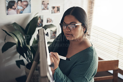 Buy stock photo Shot of a young woman using a whiteboard to teach a lesson from home