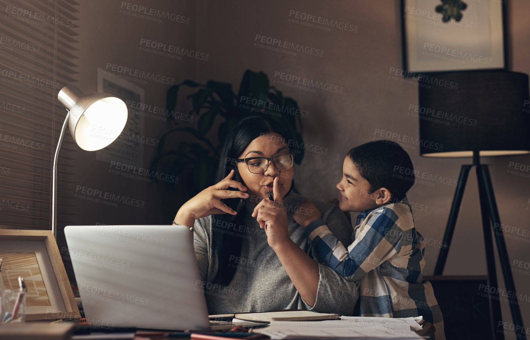 Buy stock photo Shot of an adorable little boy demanding his mother’s attention while she works at home