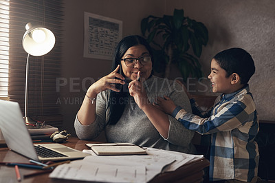 Buy stock photo Shot of an adorable little boy demanding his mother’s attention while she works at home