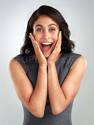 Buy stock photo Shot of a young woman looking surprised while posing against a white background