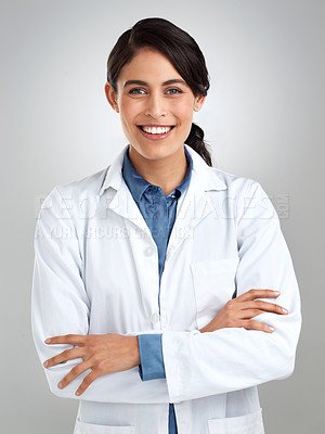 Buy stock photo Studio portrait of a confident young doctor posing against a grey background