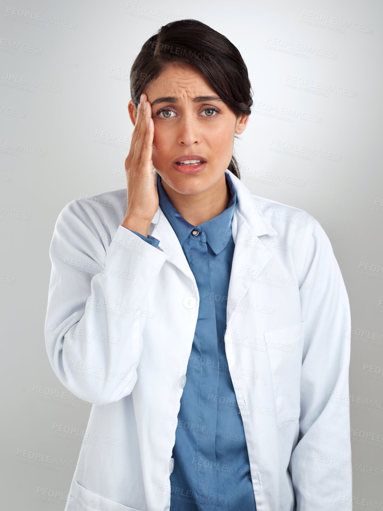 Buy stock photo Studio shot of a young doctor experiencing stress against a grey background