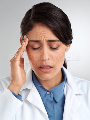 Buy stock photo Studio shot of a young doctor experiencing stress against a grey background