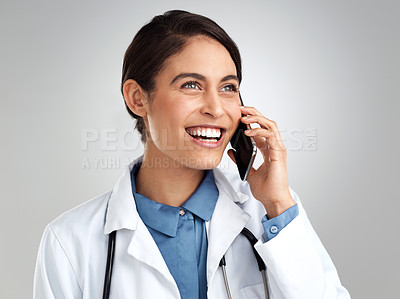 Buy stock photo Studio shot of a young doctor using a smartphone against a grey background
