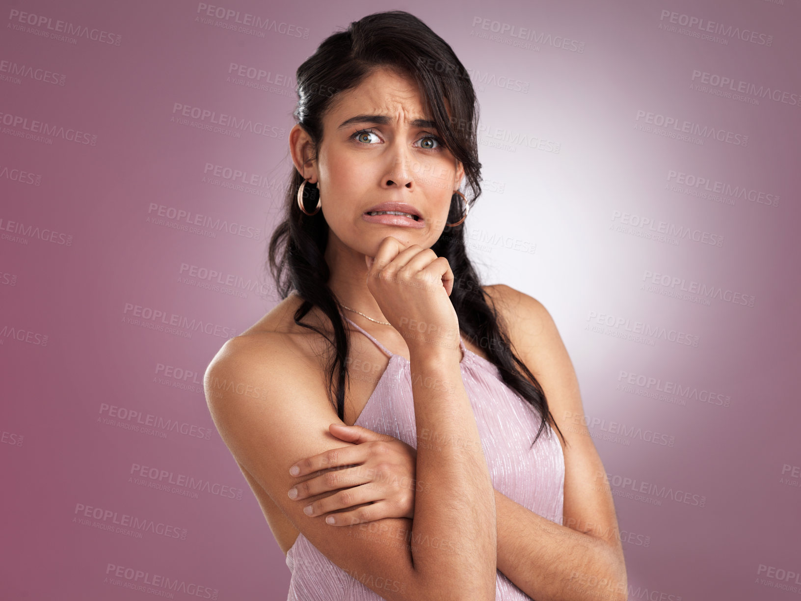 Buy stock photo Shot of a beautiful young woman  in disbelief with her arms folded and her hand resting against her chin on a pink background