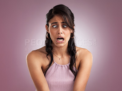 Buy stock photo Shot of a beautiful young woman looking shocked against a pink background